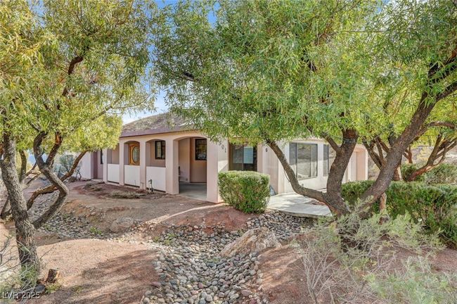 View of front of house featuring stucco siding and a porch | Image 7