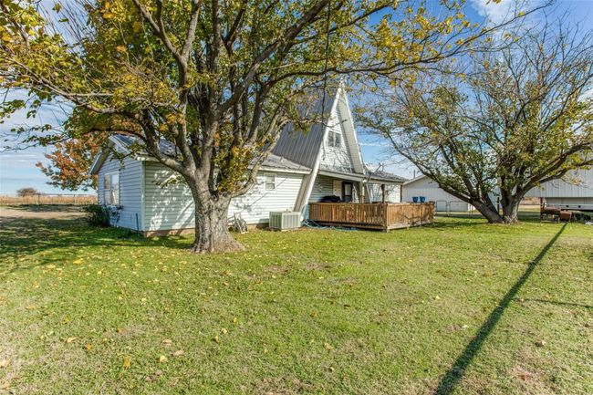View of yard featuring a deck and central AC | Image 14