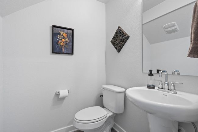 Half bath featuring toilet, baseboards, and a sink | Image 24