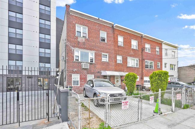 View of building exterior featuring fence private yard and a wall unit AC | Image 28