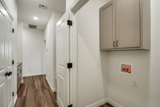 Laundry room featuring baseboards, visible vents, washer hookup, and dark wood-style flooring | Image 26