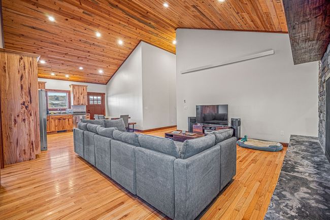 Living area with high vaulted ceiling, recessed lighting, wooden ceiling, and light wood finished floors | Image 14