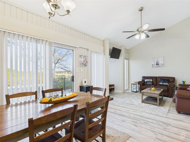 Dining room featuring vaulted ceiling. | Image 8