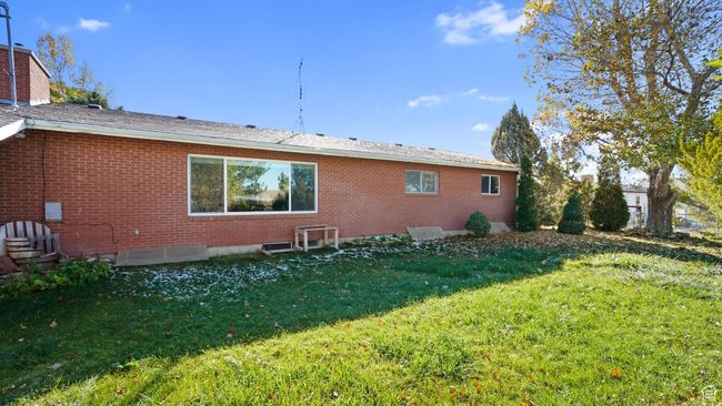 Back of house with brick siding and a lawn | Image 23