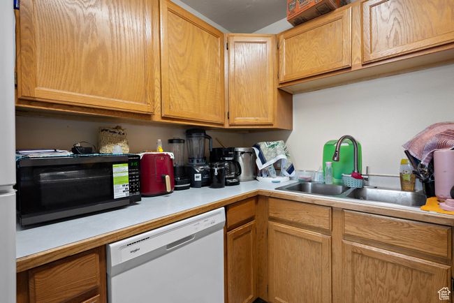 Kitchen with dishwasher, black microwave, and light countertops | Image 15