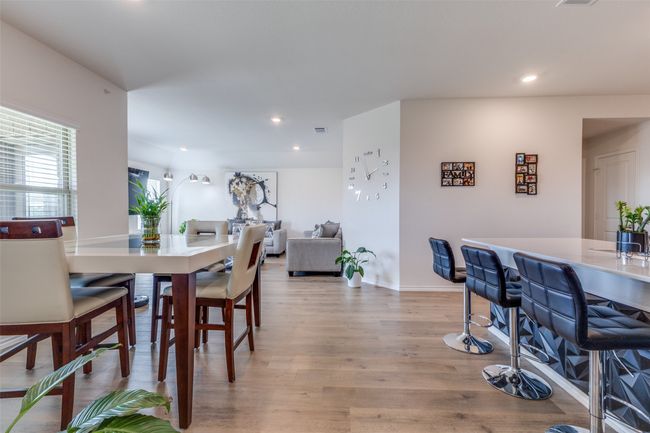 Dining room featuring baseboards, visible vents, light wood-style flooring, and recessed lighting | Image 7