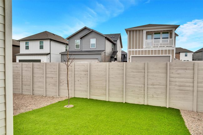 View of yard with a garage and a fenced backyard | Image 10