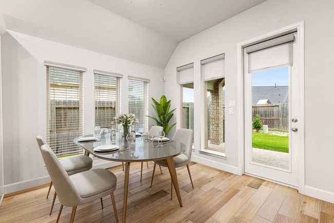 Start your day off right with a cup of coffee sitting with your family in the lovely breakfast area! Featuring large windows with blinds, neutral paint, wood like tile flooring and recessed lighting. *virtual staged* | Image 8
