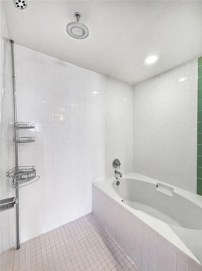 Full bathroom featuring a bath, tile walls, and tile patterned floors | Image 20
