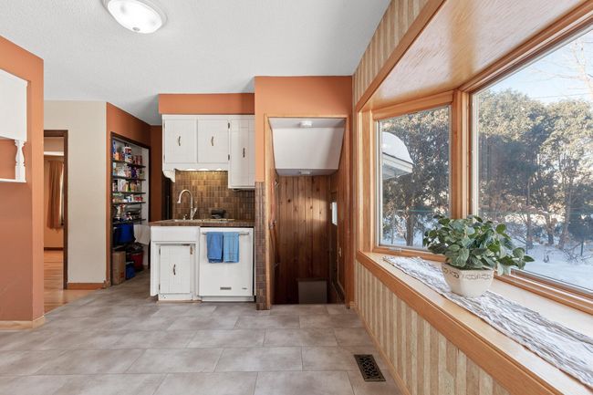 Kitchen area has small eat-in area with large bay window overlooking the rear yard. | Image 19