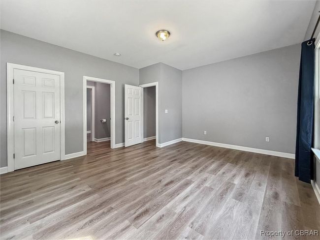 Unfurnished bedroom featuring wood finished floors and baseboards | Image 23