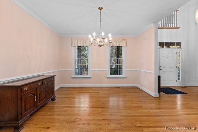 Unfurnished dining area featuring a chandelier, light wood-style floors, and crown molding | Image 20