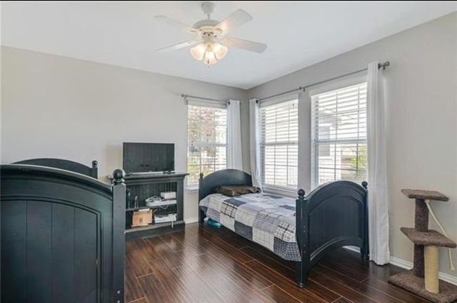 Bedroom with ceiling fan, multiple windows, and dark hardwood / wood-style flooring | Image 14