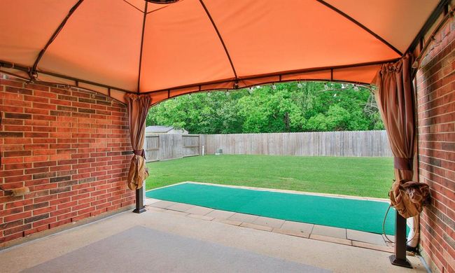 Step outside to a wonderful backyard space with canopy covered patio, green velvet landscape and NO BACK NEIGHBORS! | Image 25