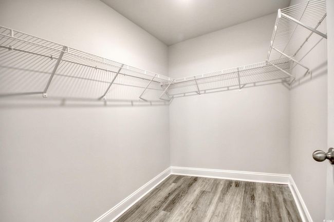 Walk in closet featuring hardwood / wood-style flooring | Image 25