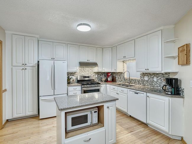 Enjoy the large kitchen with ample cabinetry and counter space. | Image 4