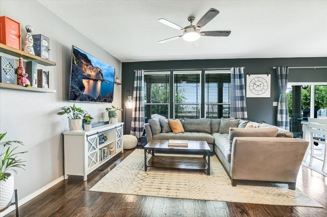 Living room with hardwood / wood-style floors, baseboards, and ceiling fan | Image 11