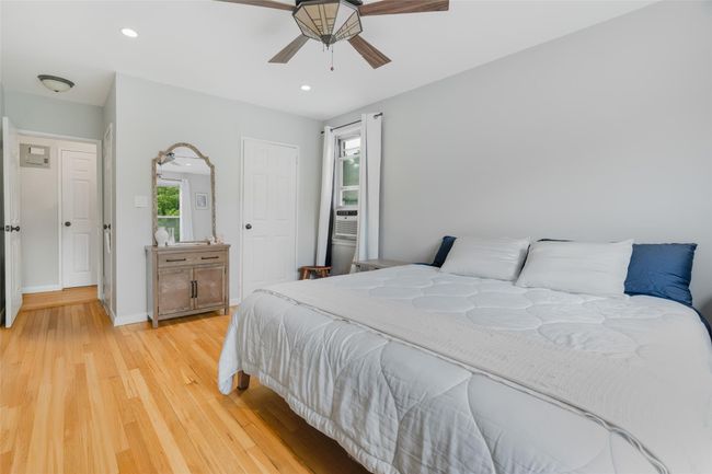 Bedroom featuring light wood-style floors, recessed lighting, ceiling fan, baseboards, and cooling unit | Image 8