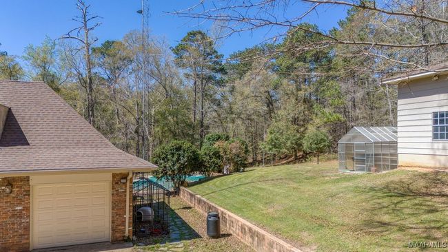 Enjoy the greenhouse! Plus there's plenty of area for a vegetable or flower garden! The greenhouse is next to the side of the equipment-storage 3 bay garage that is tall enough for motor homes. | Image 73
