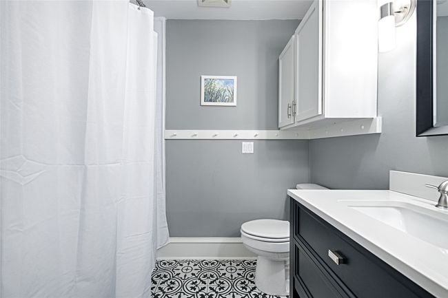 Another view of the bathroom - full tub/shower behind the curtain | Image 8