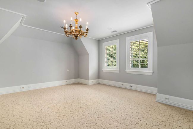 Additional living space featuring a chandelier and lofted ceiling | Image 34