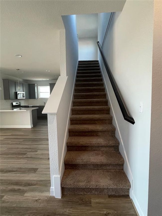 Stairs featuring wood finished floors and recessed lighting | Image 16
