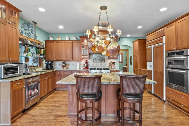 Kitchen viewed toward breakfast bar and showing all appliances. | Image 7