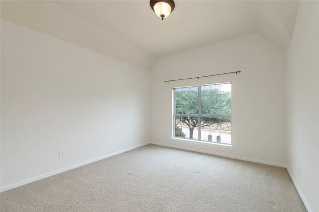 Carpeted empty room featuring vaulted ceiling and baseboards | Image 28