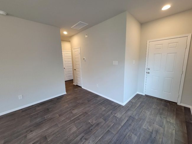 Unfurnished room with dark wood finished floors, recessed lighting, and a smoke detector | Image 8
