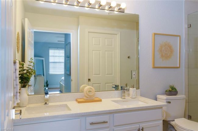 Bathroom featuring ensuite bathroom, a sink, toilet, and double vanity | Image 13