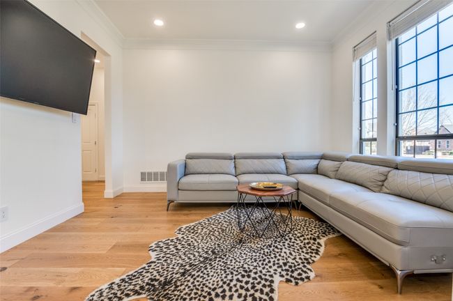 Living area with visible vents, baseboards, ornamental molding, recessed lighting, and light wood-type flooring | Image 15