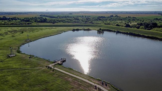 Aerial view of sparsely populated area featuring a large body of water | Image 17