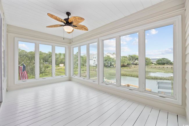 Unfurnished sunroom with a water view | Image 14