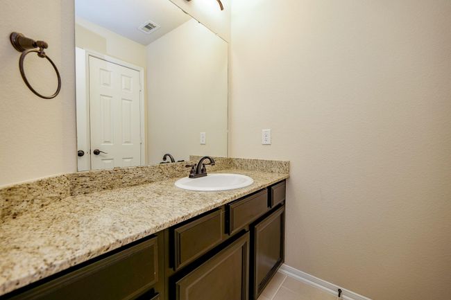 The half-bath ? is true to color themes in this glorious home! | Image 29