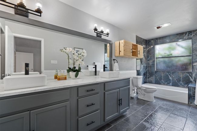 Bathroom featuring double vanity and shower / bath combination | Image 16