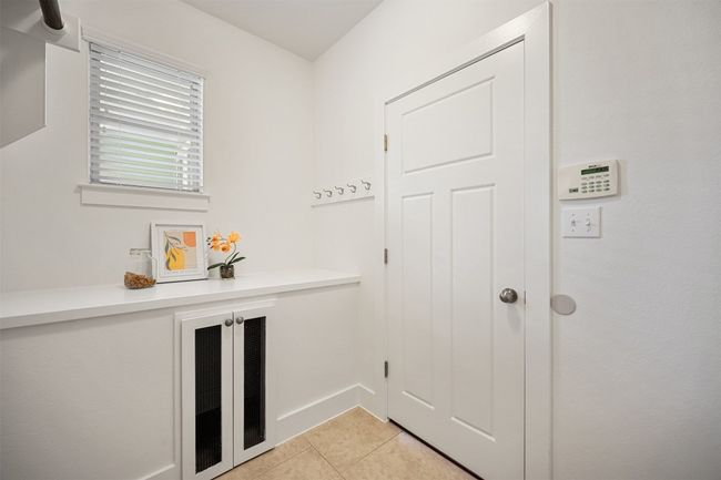 The laundry room featuring the Pet Suite, with direct access to outside, conveniently located with direct access to the one-car garage, makes chore time easier by keeping everything within reach | Image 32