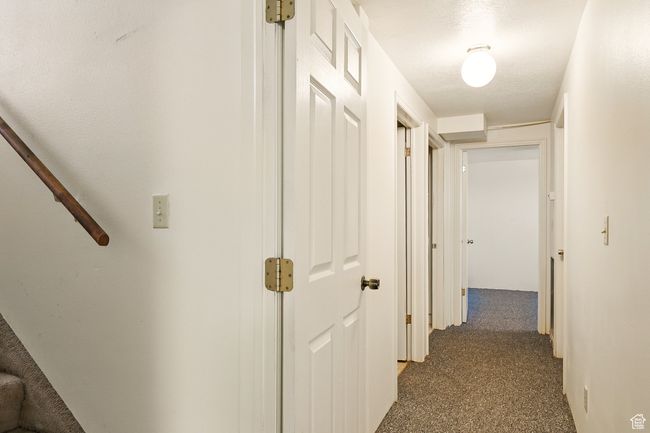 Hall featuring dark carpet | Image 27