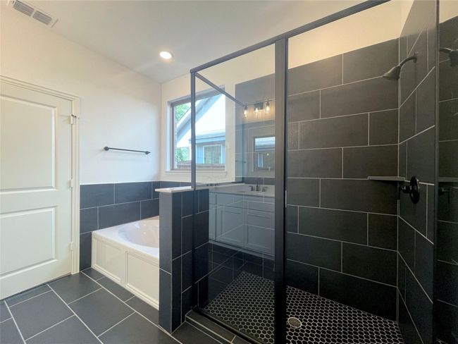 Bathroom with a stall shower, a garden tub, tile patterned floors, vanity, and recessed lighting | Image 14