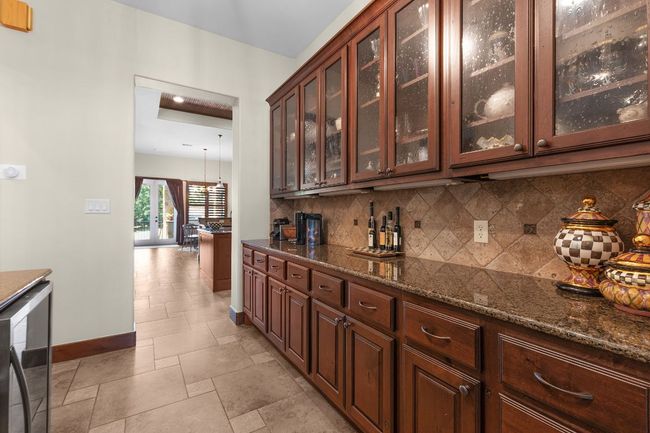 Indoor dry bar featuring tasteful backsplash | Image 8