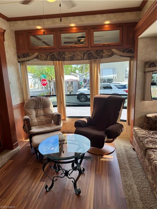 Living room with plenty of natural light, crown molding, and dark hardwood / wood-style floors | Image 25