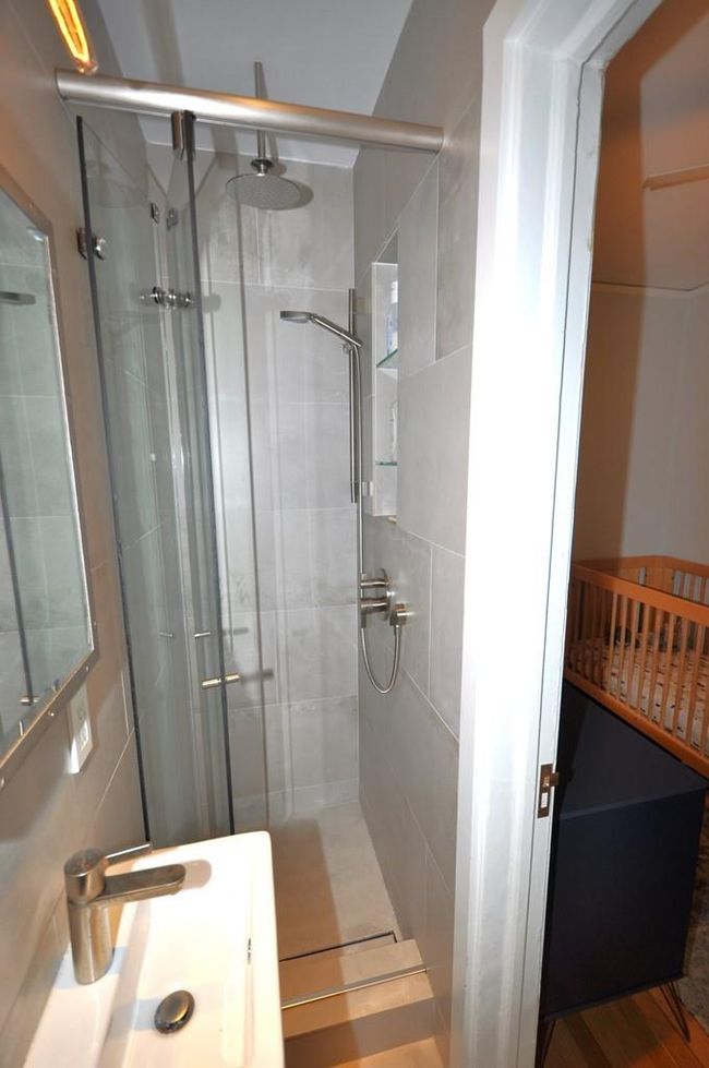 View 2 of the Renovated private bath off of the third bedroom, has step in shower, window for ventilation and heated floor. | Image 29