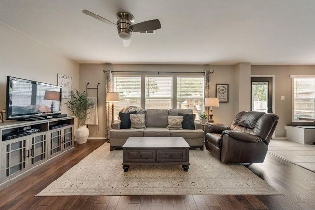 Living area with ceiling fan and wood-type flooring | Image 4