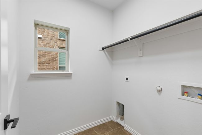 Laundry room featuring hookup for a gas dryer, washer hookup, laundry area, electric dryer hookup, and baseboards | Image 19