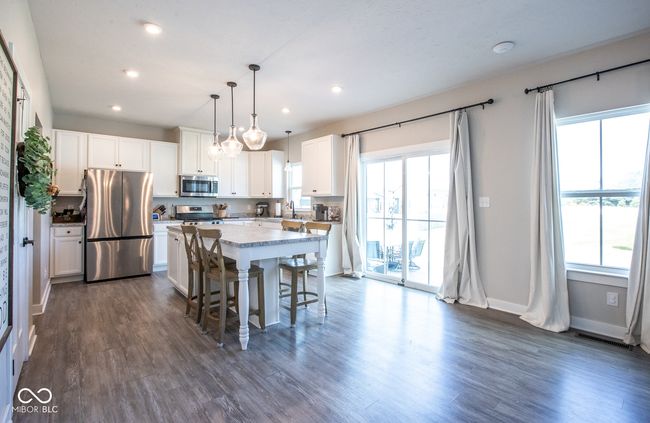 kitchen featuring appliances with stainless steel finishes, plenty of natural light, white cabinets, and recessed lighting | Image 13