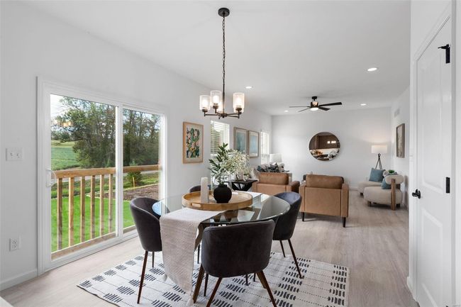 Dining room featuring ceiling fan with notable chandelier and light hardwood / wood-style flooring | Image 9