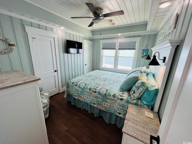 Bedroom featuring a raised ceiling, wooden ceiling, dark hardwood / wood-style floors, and ceiling fan | Image 16