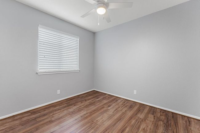 Guest Bedroom 2 with ceiling fan and wood finished floors | Image 20