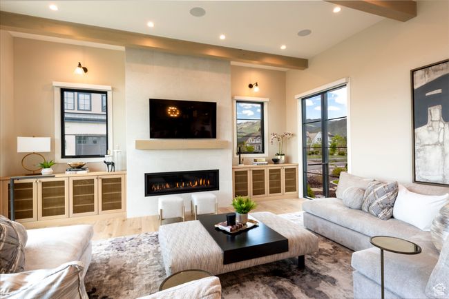 Living room featuring wood finished floors, a large fireplace, and recessed lighting | Image 13