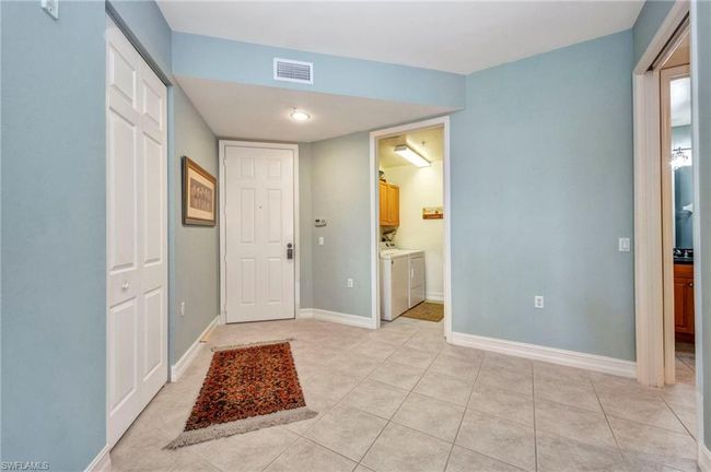 Entrance foyer with washer and clothes dryer and light tile patterned flooring | Image 5