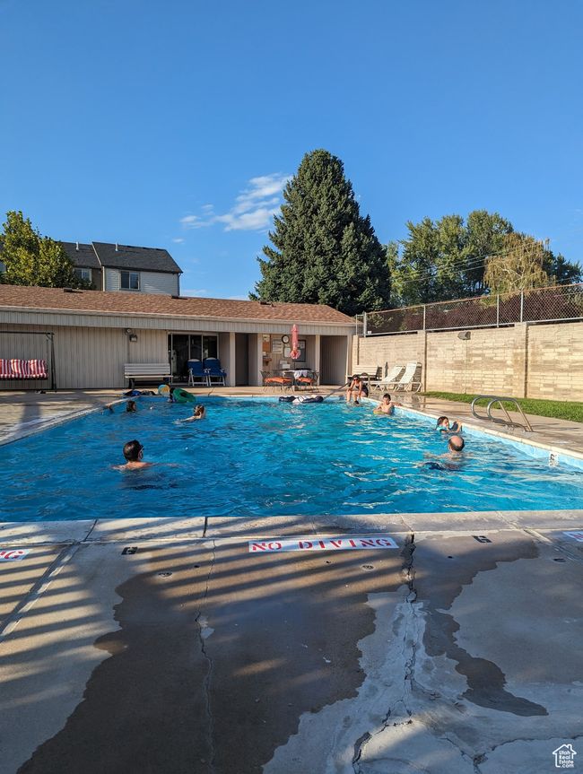 Community pool featuring fence and a patio area | Image 34